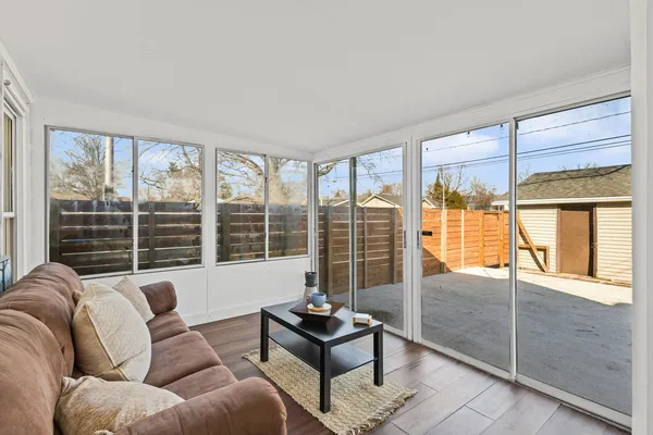a living room with furniture and a floor to ceiling window