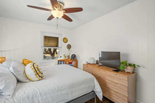 a bedroom with a bed and a chandelier