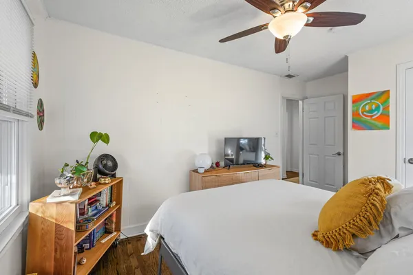 a bedroom with a bed and a chandelier
