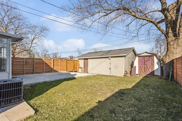 a view of a backyard with a large tree