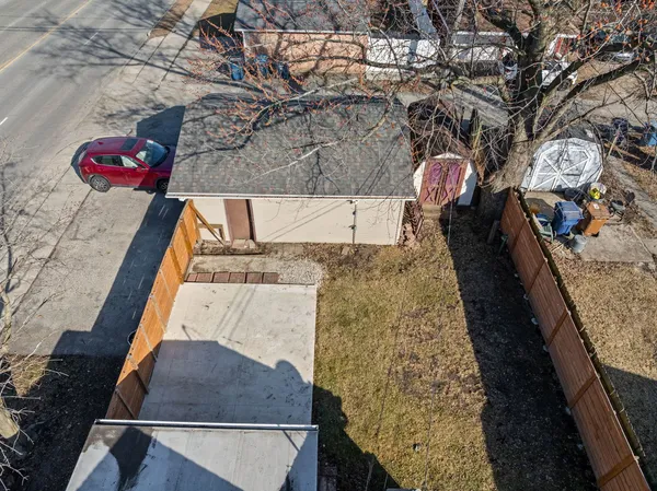 an aerial view of a house with large trees