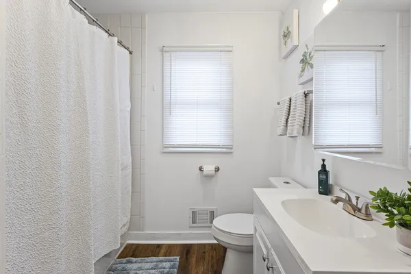 a bathroom with a sink toilet and shower