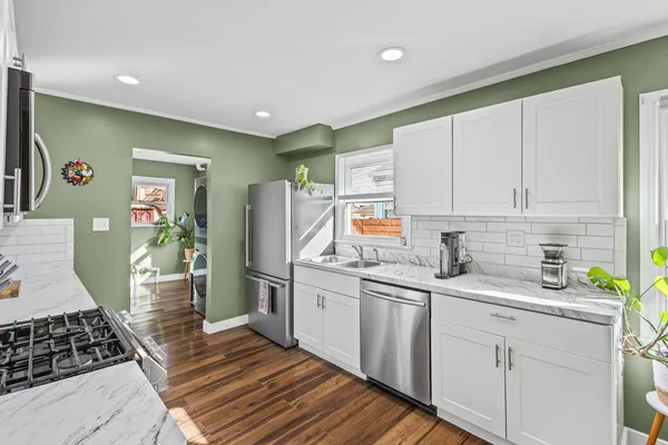 a kitchen with sink a stove and cabinets