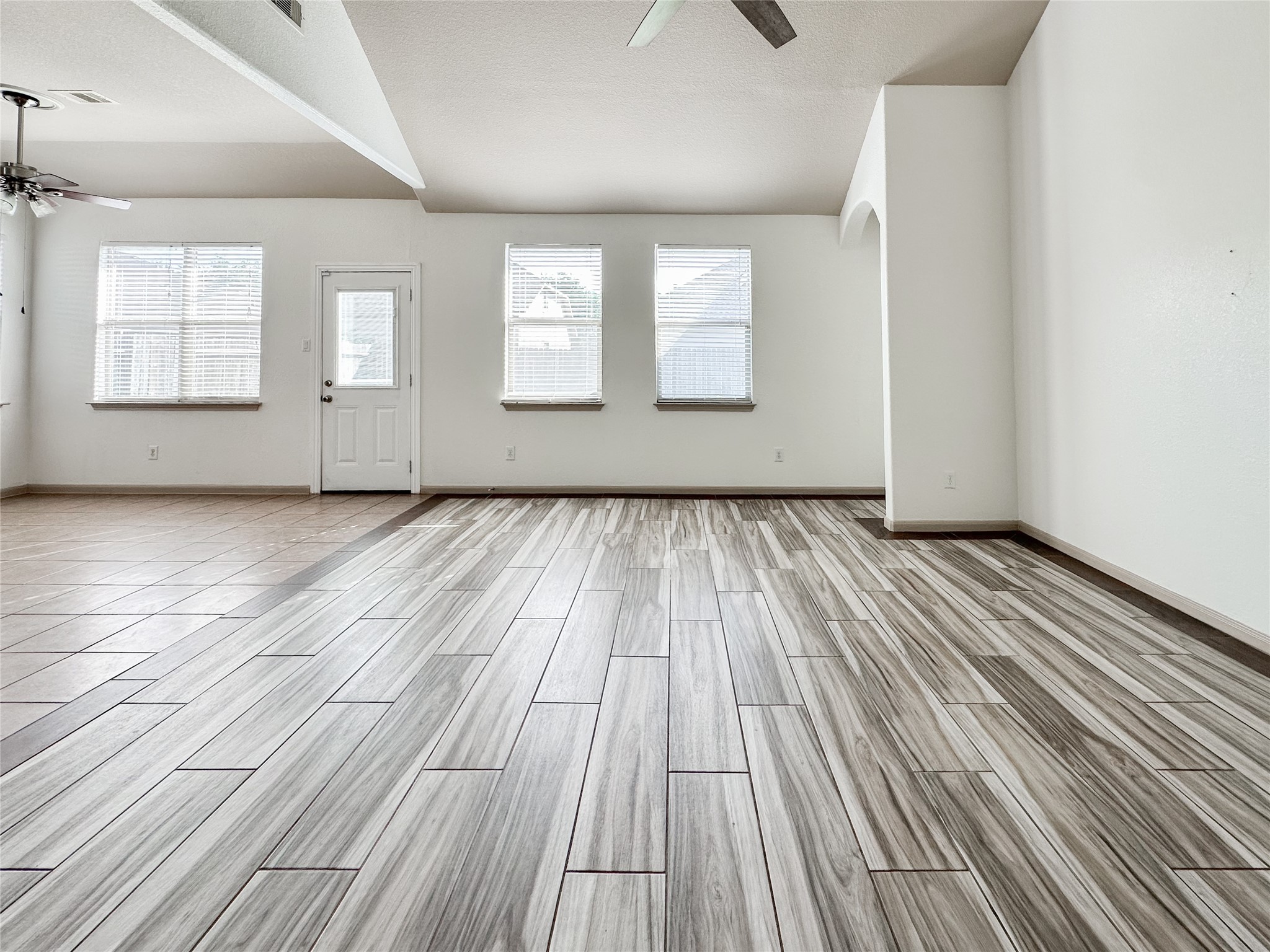 20319 Little Wing Drive Spring, TX 77388 - Photo 19 of 49 an empty room with wooden floor and windows