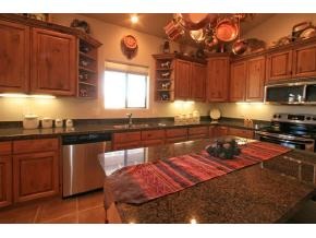 2375 North Reed Road, Unit 1 Chino Valley, AZ 86323 - Photo 5 of 9 a kitchen with stainless steel appliances granite countertop a stove a sink dishwasher and cabinets with wooden floor
