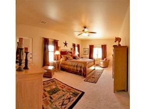 2375 North Reed Road, Unit 1 Chino Valley, AZ 86323 - Photo 7 of 9 a bedroom with a bed lamps and a large mirror