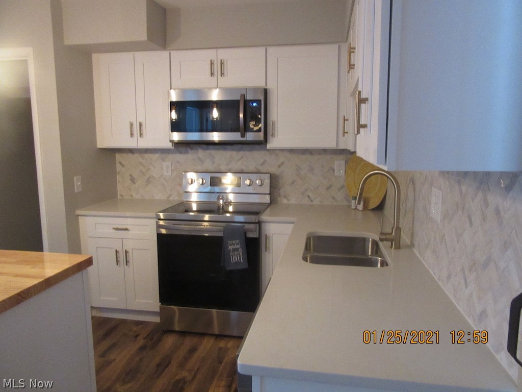 3749 Blackmore Road Perry, OH 44081 - Photo 6 of 25 kitchen w/ quartz countertops and tiled herringbone backsplash