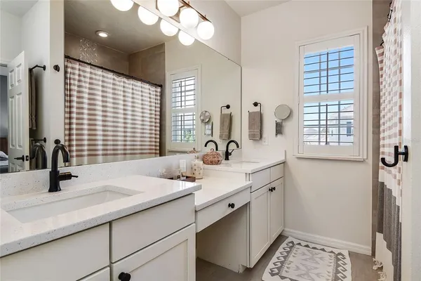 a bathroom with a double vanity sink and a mirror