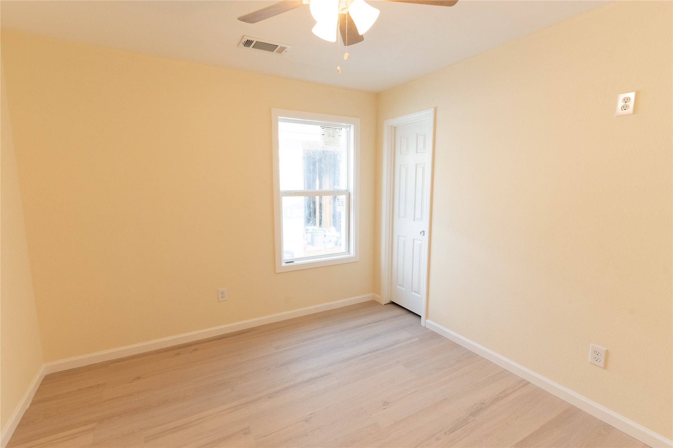 4425 7th Street Bacliff, TX 77518 - Photo 12 of 16 an empty room with a window and a chandelier