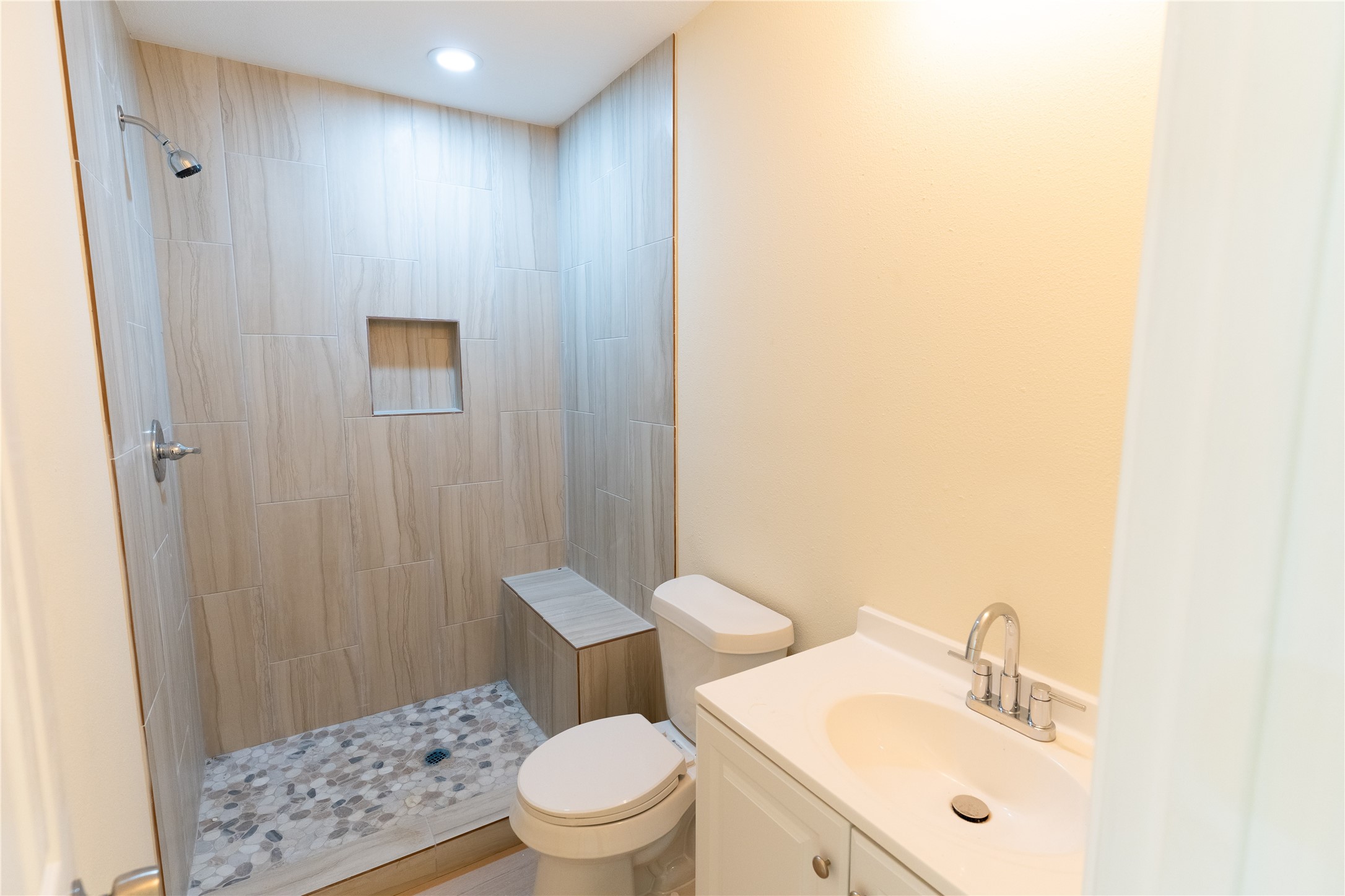 4425 7th Street Bacliff, TX 77518 - Photo 14 of 16 a bathroom with a sink a toilet and shower