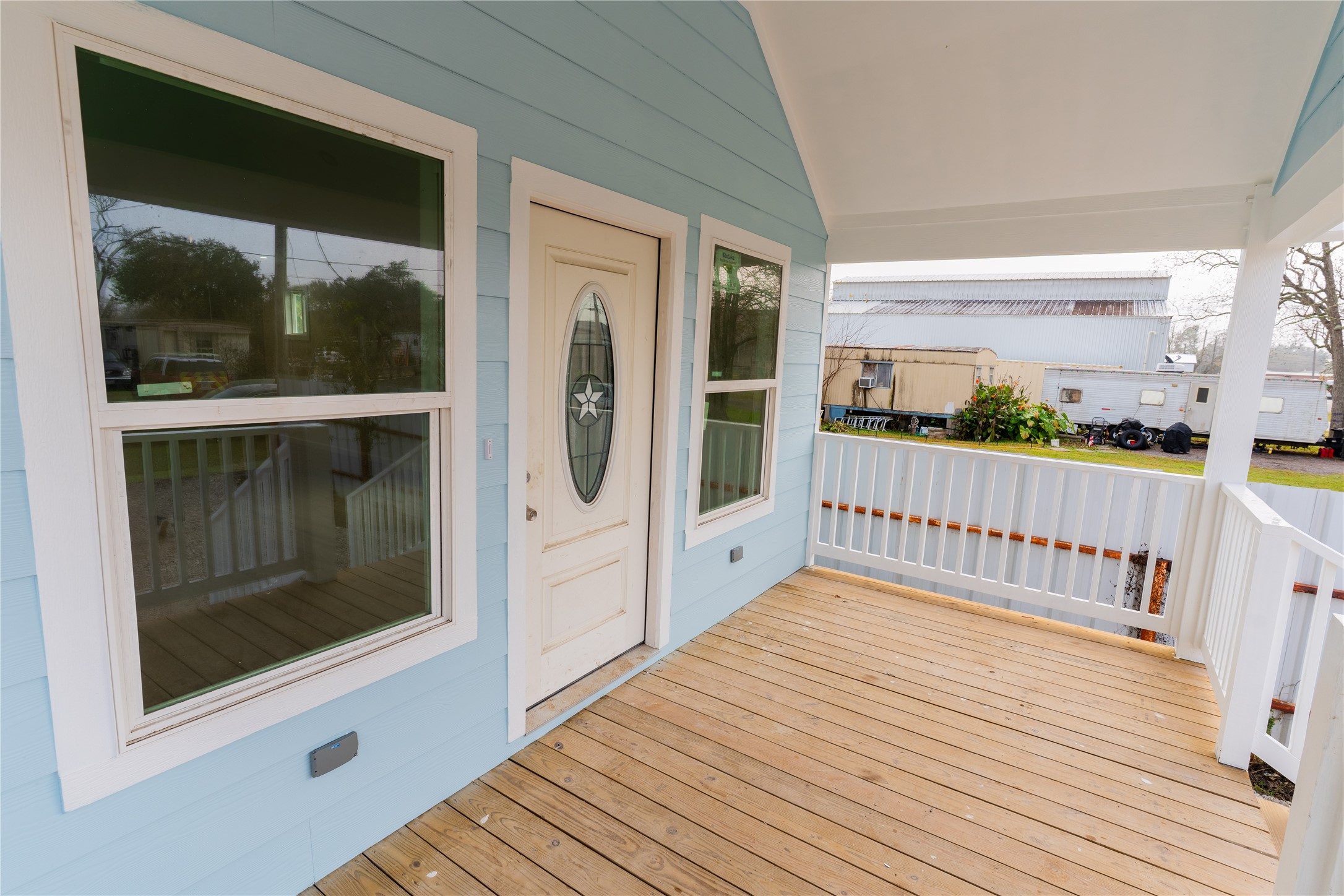 4425 7th Street Bacliff, TX 77518 - Photo 3 of 16 a view of a porch with wooden floor and floor to ceiling window