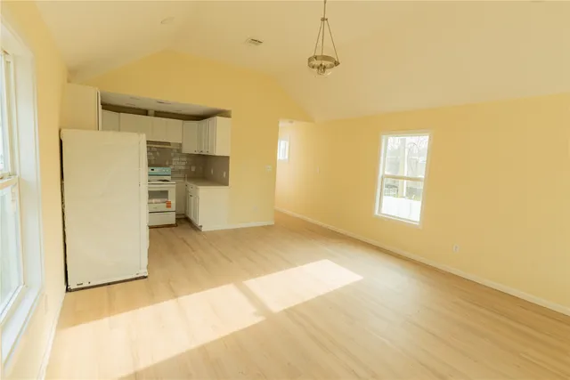 a view of a kitchen with a sink and a refrigerator