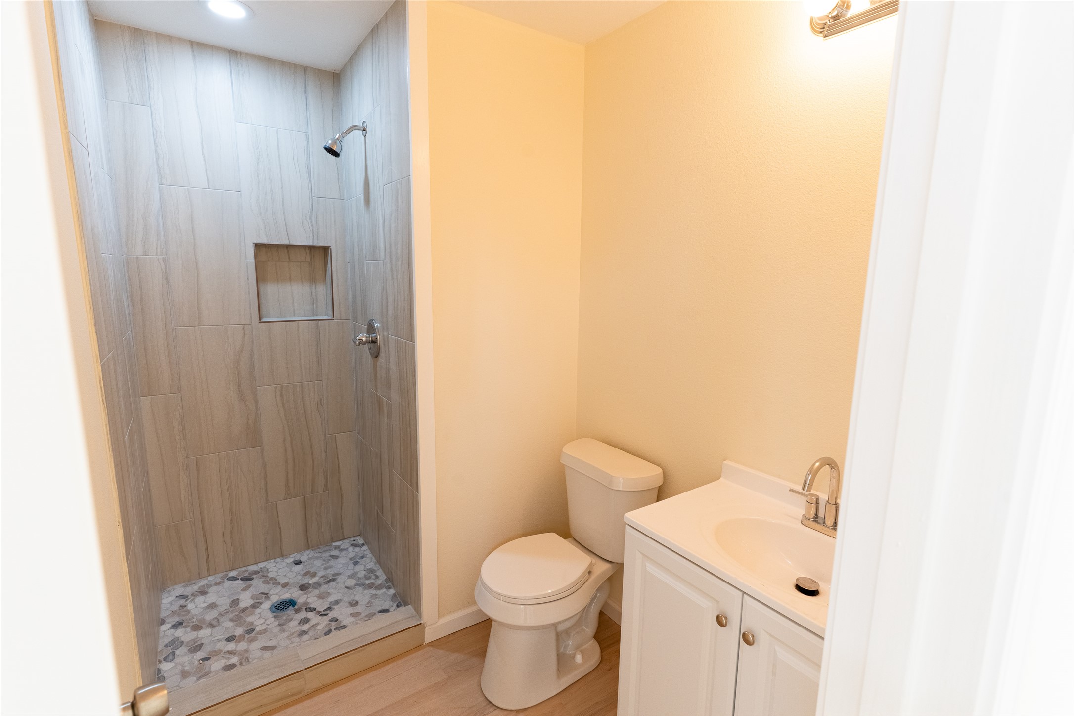 4425 7th Street Bacliff, TX 77518 - Photo 9 of 16 a white toilet sitting next to a bathroom sink