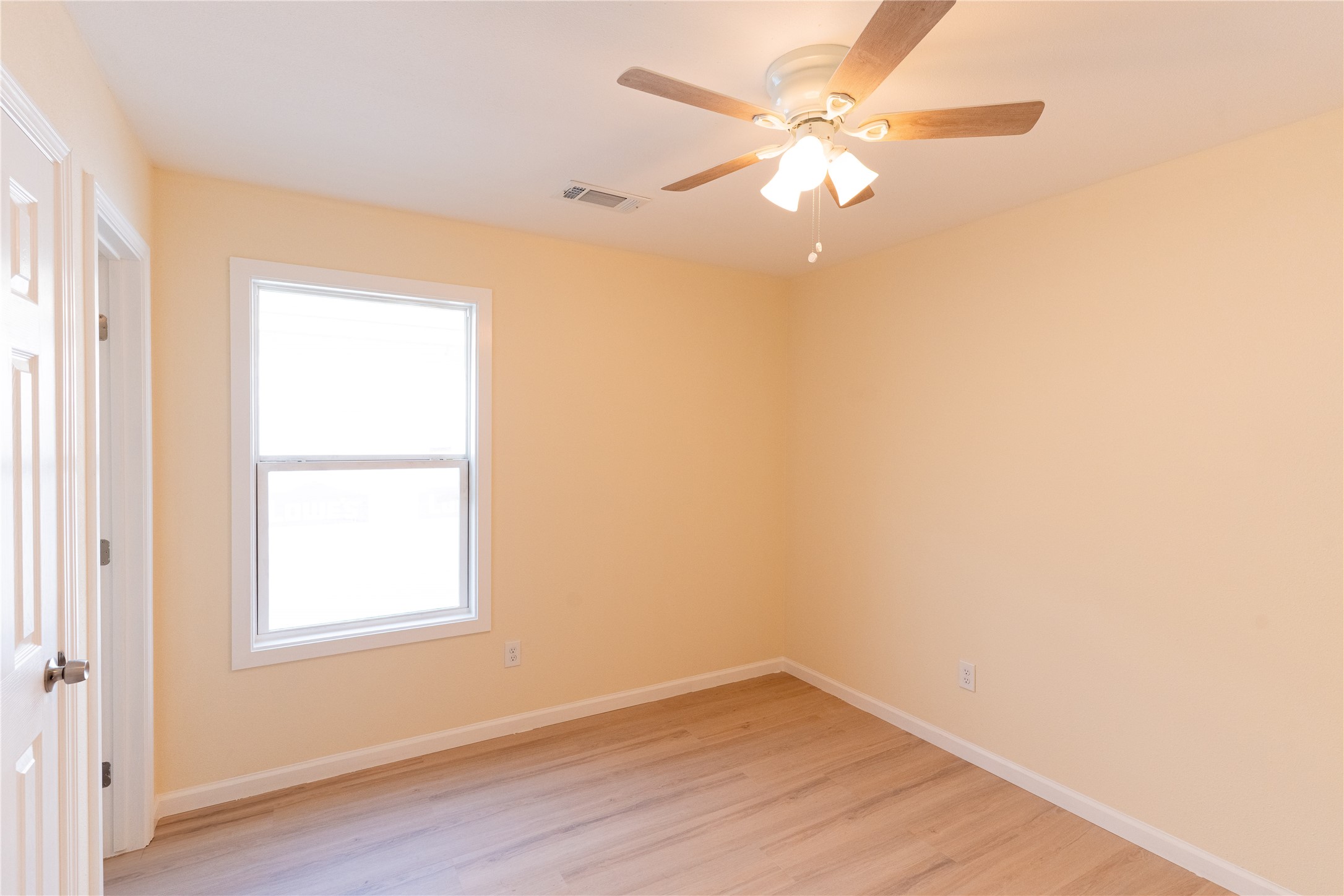 4425 7th Street Bacliff, TX 77518 - Photo 10 of 16 an empty room with a window and a fan