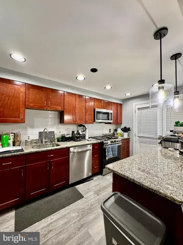 a kitchen with stainless steel appliances granite countertop a stove and a sink