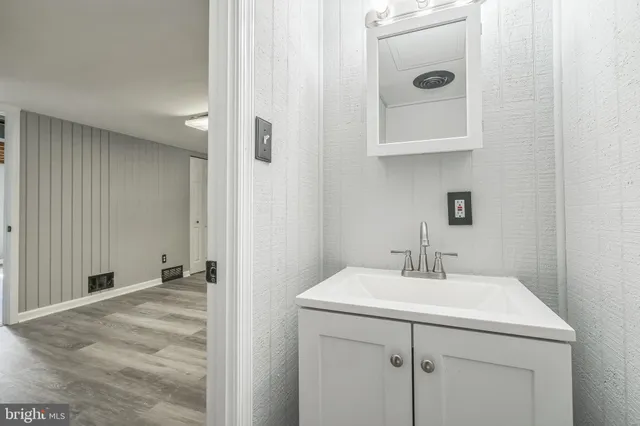 a bathroom with a sink and mirror