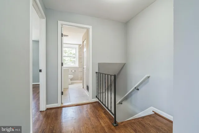 a view of a hallway with wooden floor and entryway