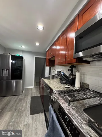 a kitchen with stainless steel appliances granite countertop a stove and a refrigerator