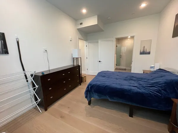 a bedroom with a bed and cabinets