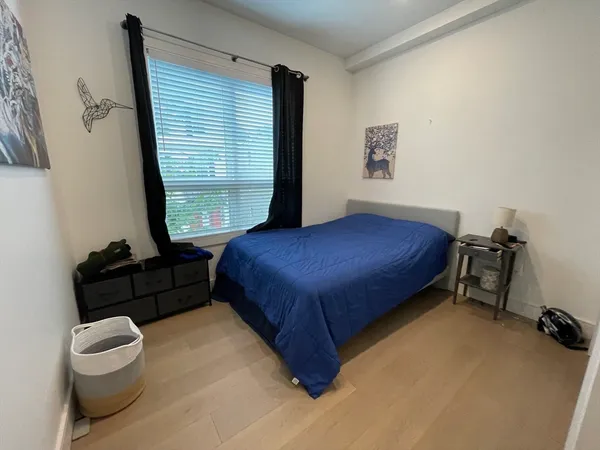 a bedroom with a bed and a window