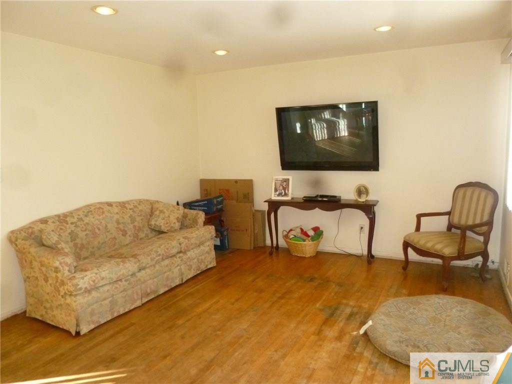 108 Kimberly Road Colonia, NJ 07067 - Photo 5 of 14 a living room with furniture and a flat screen tv