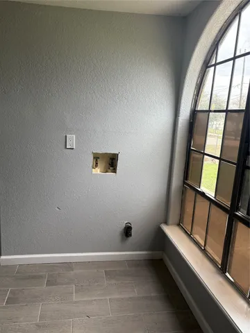 a view of a livingroom with a ceiling fan and window