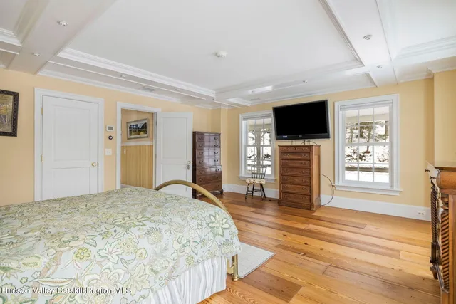 a bedroom with a large bed and a rug