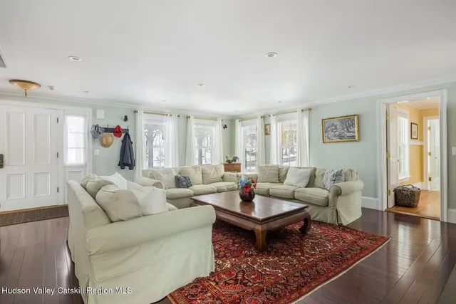 a dining room with furniture a chandelier and wooden floor