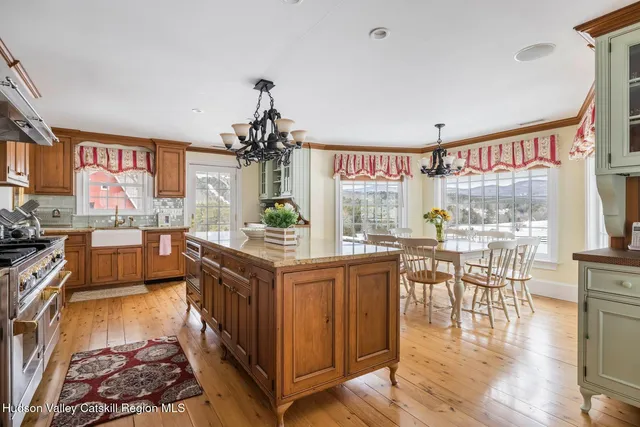 a kitchen with stainless steel appliances granite countertop a stove and cabinets