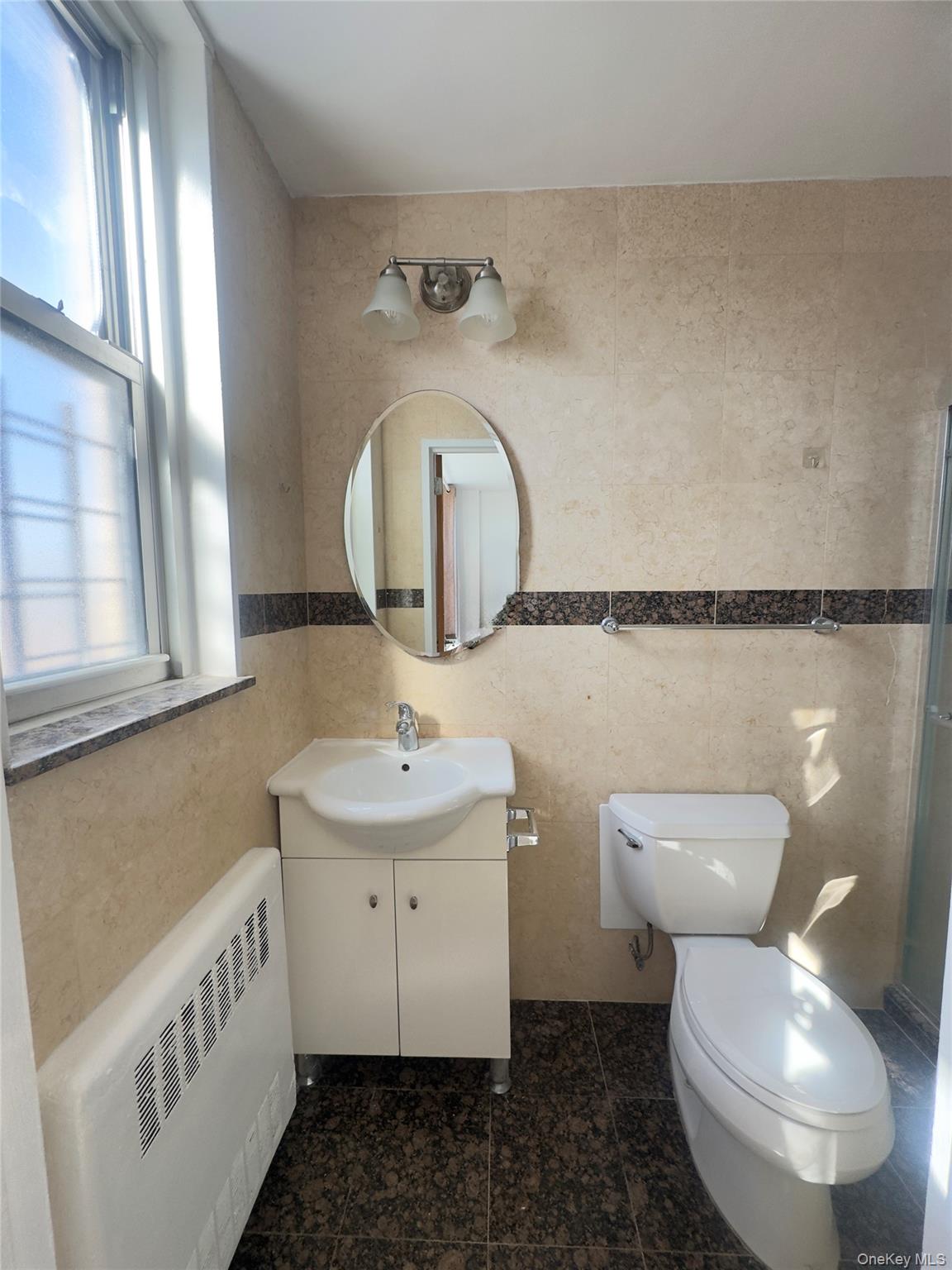 41-40 Union Street, Unit 16D Queens, NY 11355 - Photo 11 of 12 a bathroom with a toilet sink and mirror