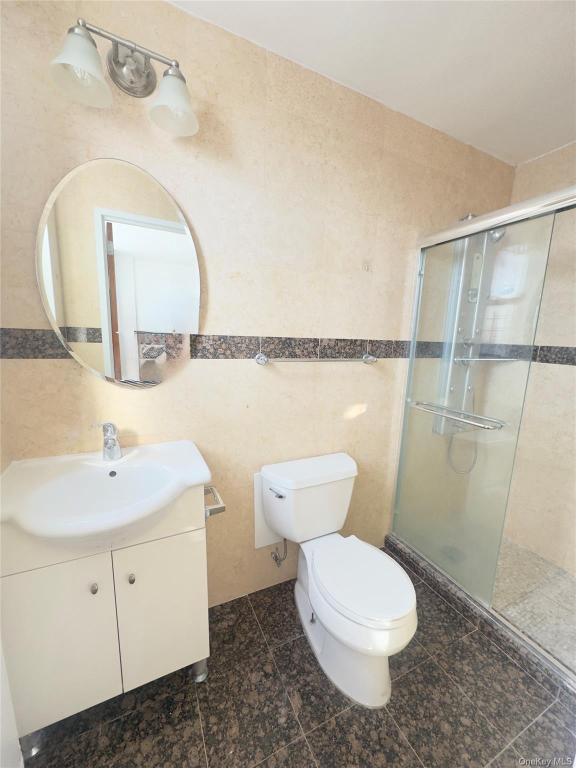 41-40 Union Street, Unit 16D Queens, NY 11355 - Photo 12 of 12 a bathroom with a toilet a sink and a mirror