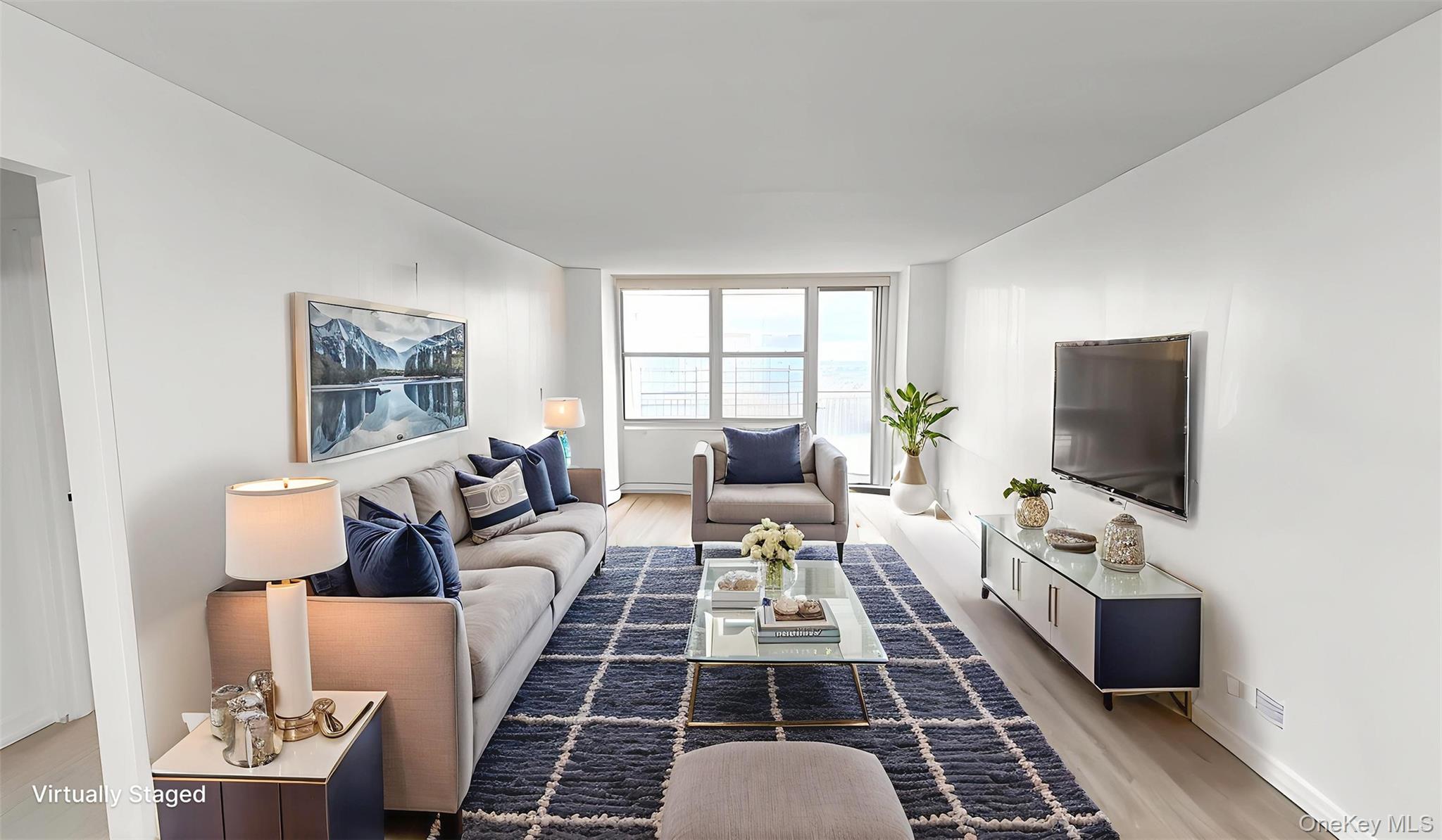 41-40 Union Street, Unit 16D Queens, NY 11355 - Photo 4 of 12 a living room with furniture and a flat screen tv