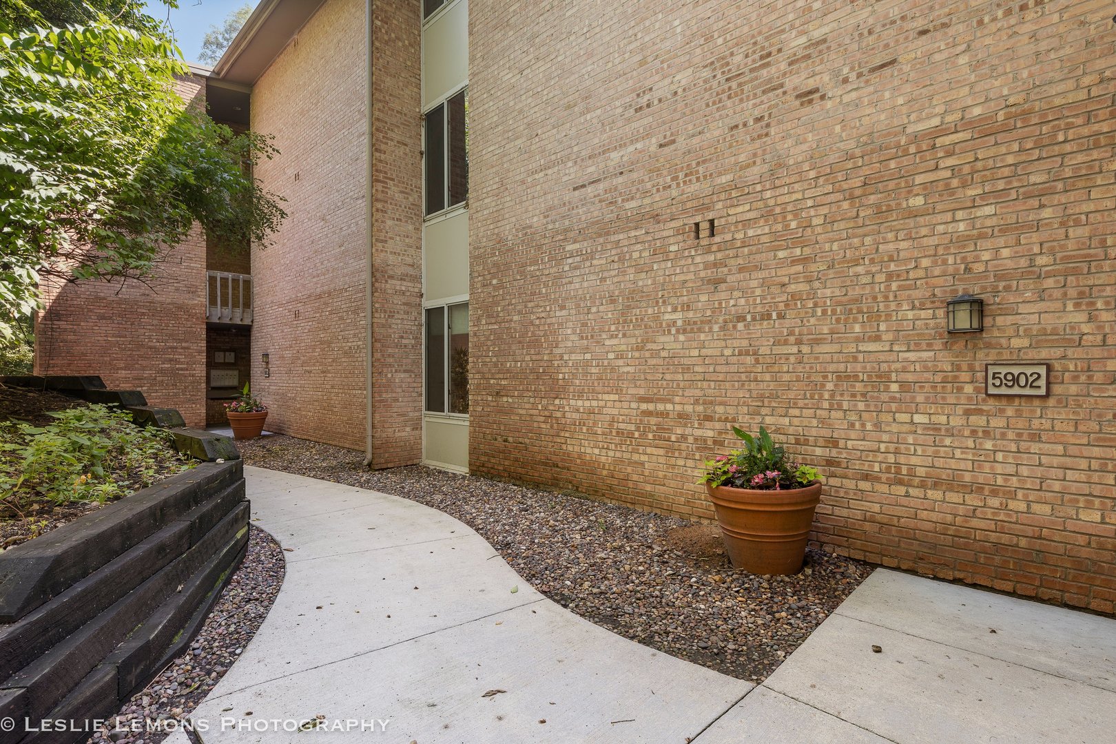 5902 Forest View Road, Unit 1C Lisle, IL 60532 - Photo 1 of 34 a view of a backyard of a house with potted plants