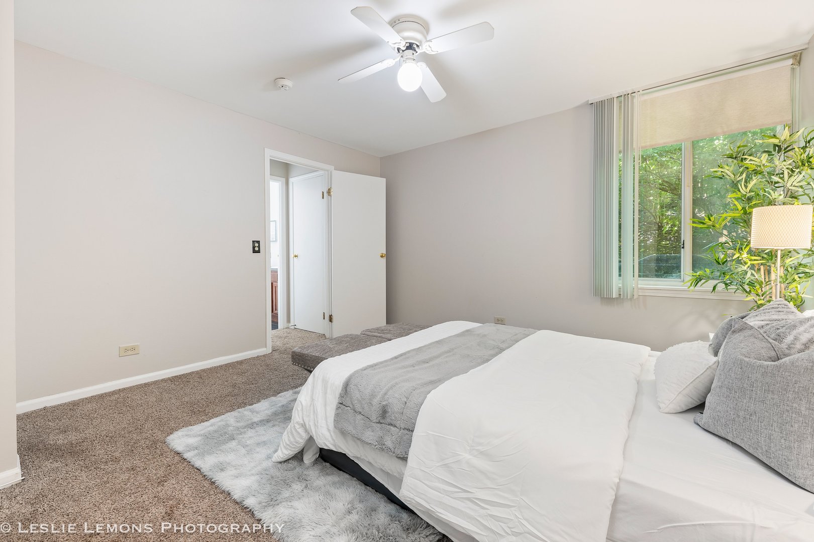 5902 Forest View Road, Unit 1C Lisle, IL 60532 - Photo 13 of 34 a spacious bedroom with a bed and a chandelier