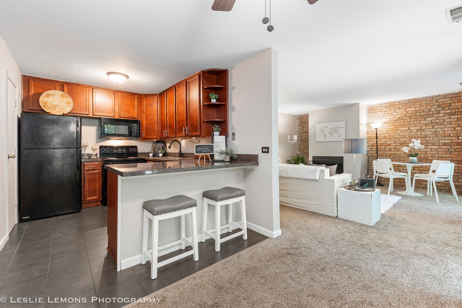 5902 Forest View Road, Unit 1C Lisle, IL 60532 - Photo 9 of 34 a kitchen with stainless steel appliances granite countertop a stove a sink a refrigerator and white cabinets