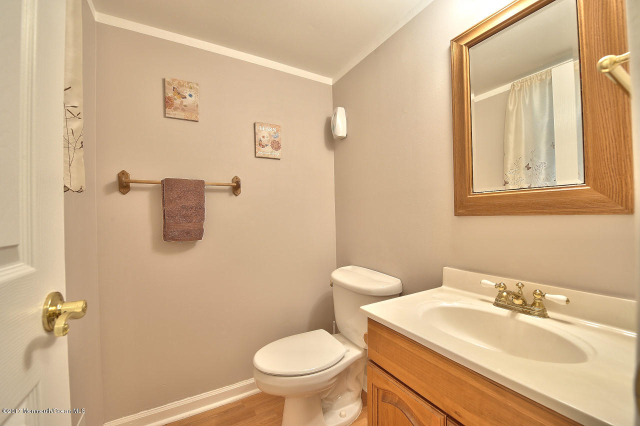 90 Starlight Road Howell, NJ 07731 - Photo 12 of 40 a bathroom with a sink toilet and mirror