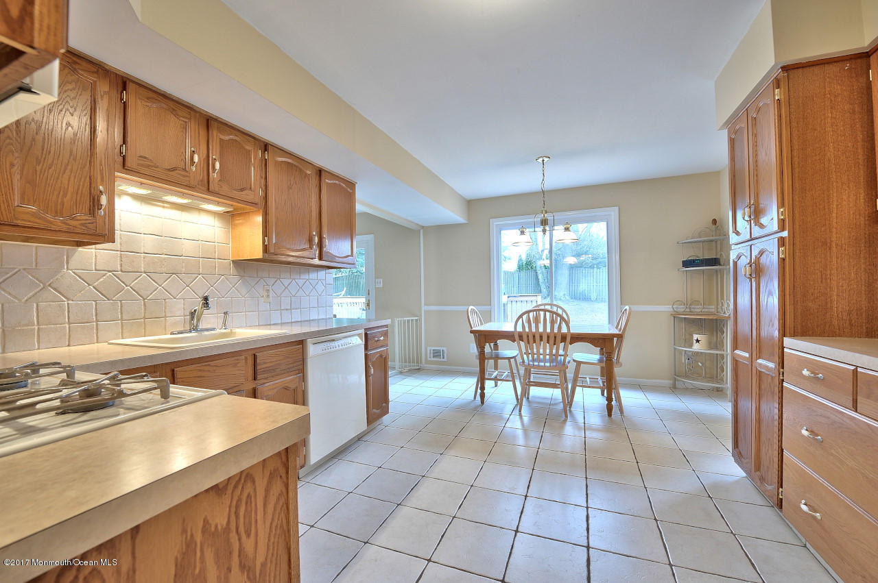 90 Starlight Road Howell, NJ 07731 - Photo 13 of 40 a view of a kitchen tables a sink and a microwave