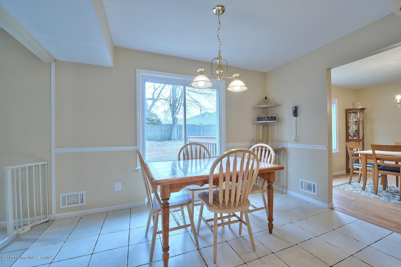 90 Starlight Road Howell, NJ 07731 - Photo 20 of 40 a dining room with furniture a chandelier and window