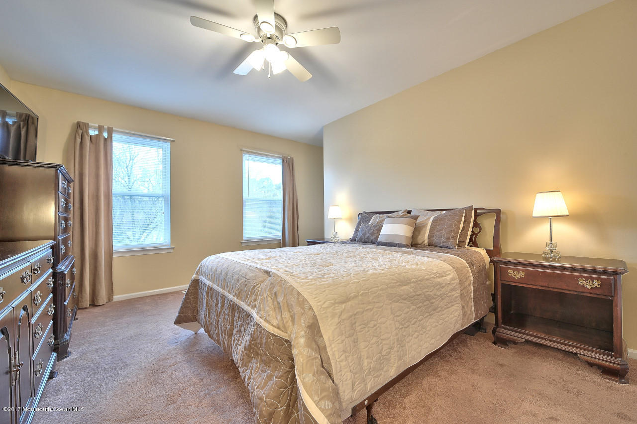 90 Starlight Road Howell, NJ 07731 - Photo 25 of 40 a bedroom with a bed and a flat tv screen on dresser