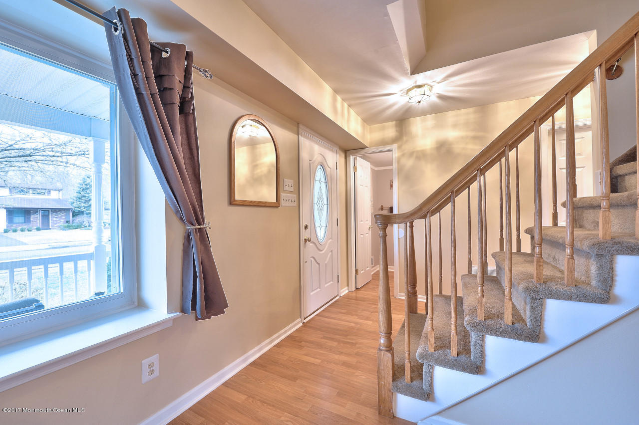 90 Starlight Road Howell, NJ 07731 - Photo 4 of 40 a view of staircase with lots of frames and frames on wall and windows