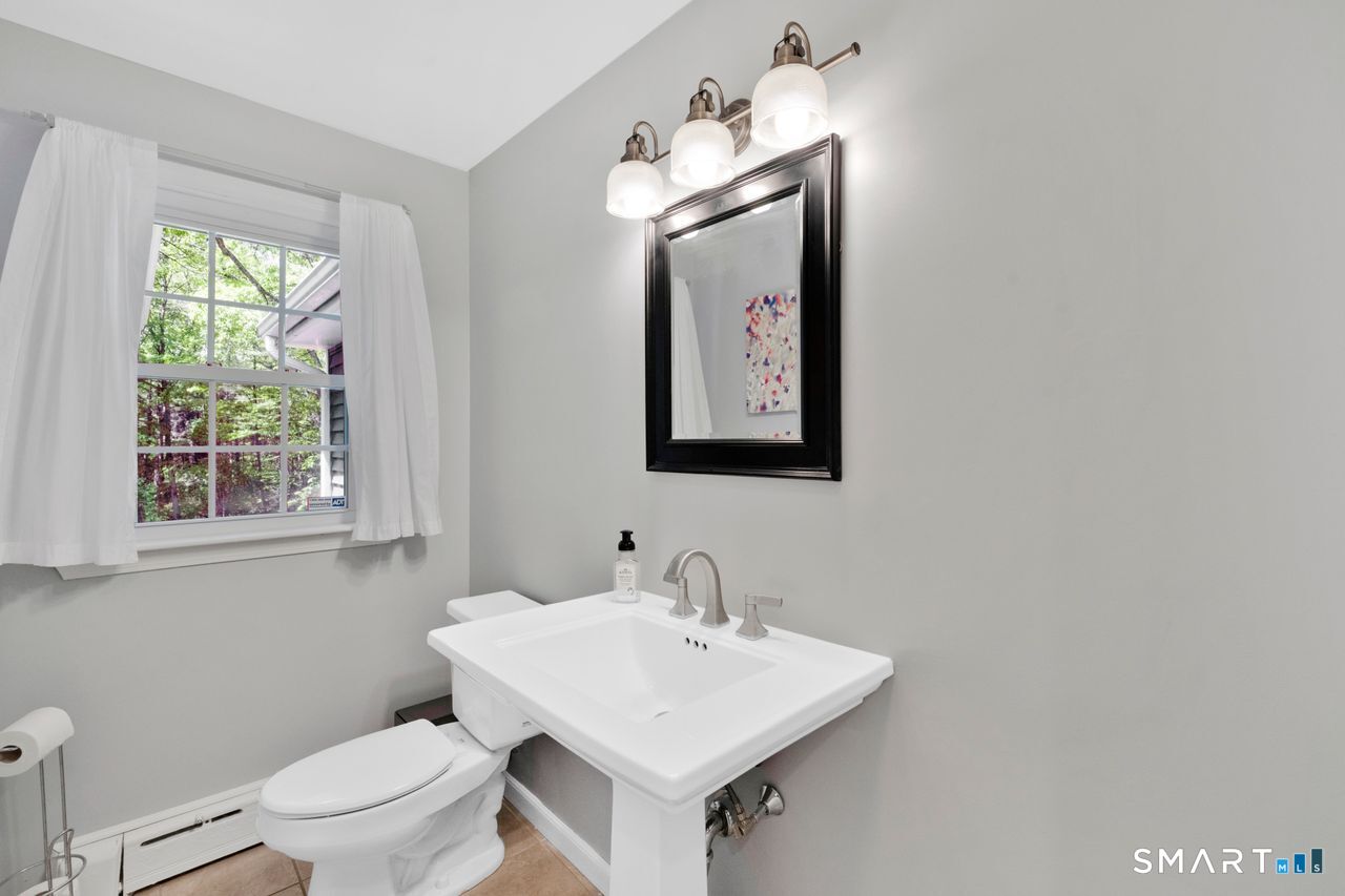1013 Ratley Road Suffield, CT 06093 - Photo 22 of 39 a bathroom with a toilet sink and mirror