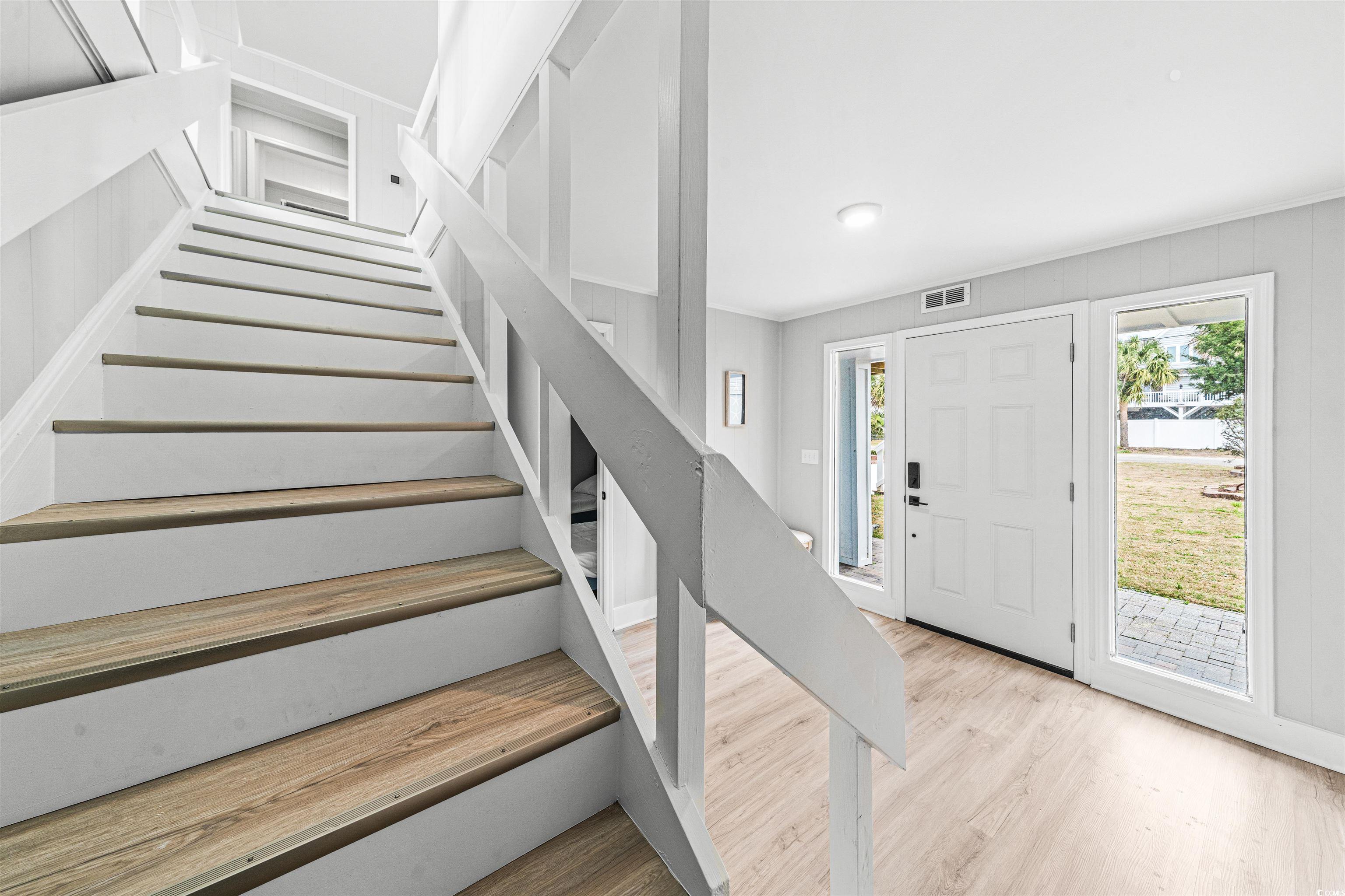 338 State Rd S-26-530 Murrells Inlet, SC 29576 - Photo 8 of 39 Entrance foyer with wood finished floors, stairs, and visible vents
