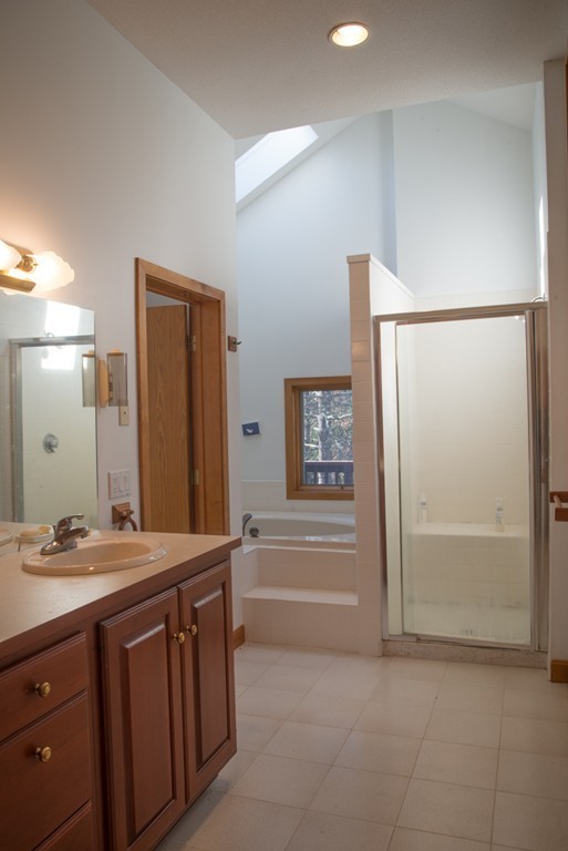 61 South Valley Road Amherst, MA 01002 - Photo 23 of 38 a bathroom with a double vanity sink a mirror and a bathtub