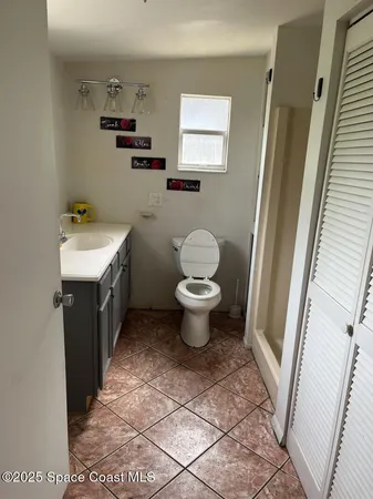 a bathroom with a sink toilet and a mirror