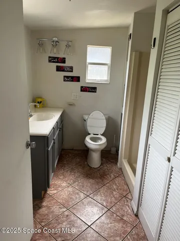 a bathroom with a sink toilet and a mirror