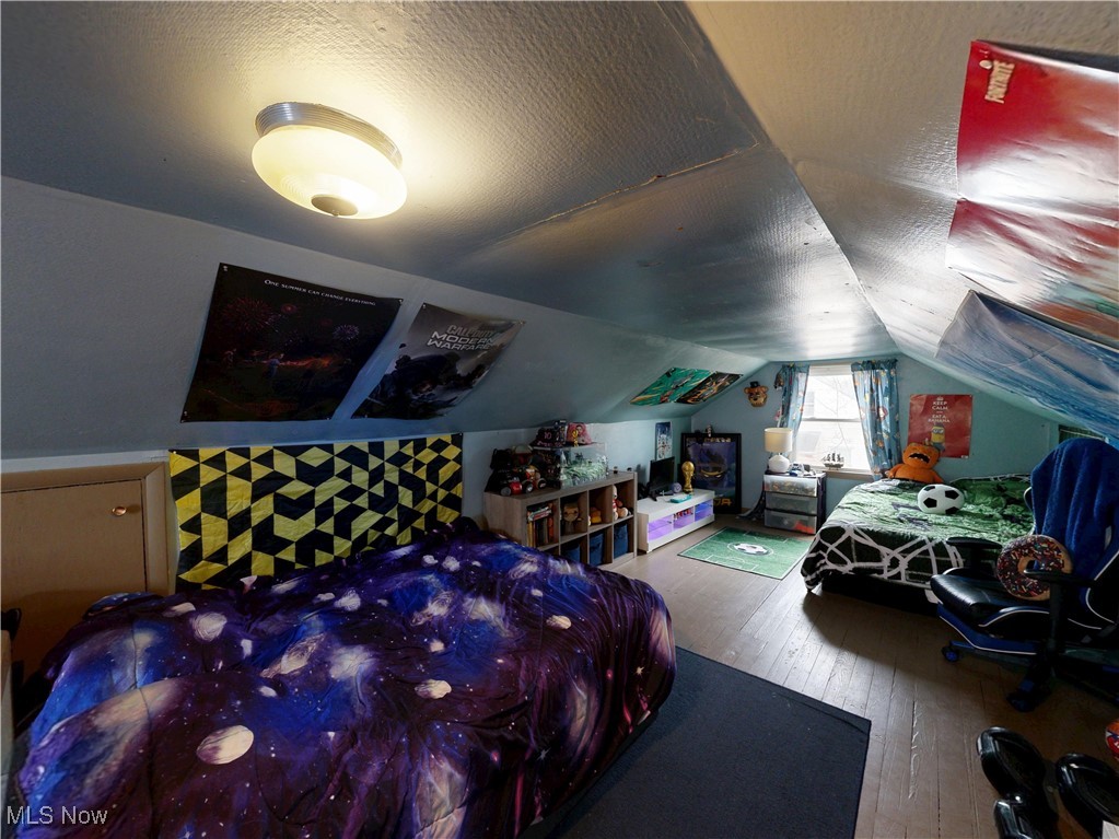 1004 Rice Street Alliance, OH 44601 - Photo 27 of 32 Bedroom with lofted ceiling, hardwood / wood-style flooring, and a textured ceiling