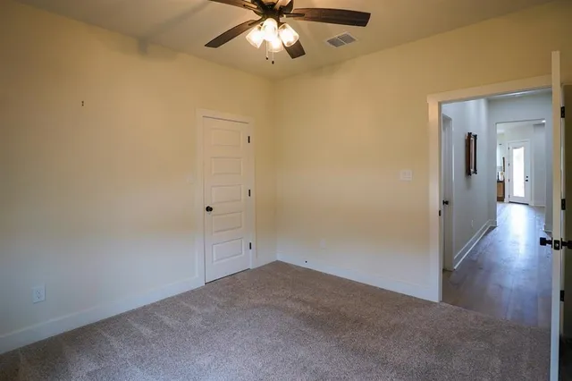 a view of a hallway with a chandelier fan