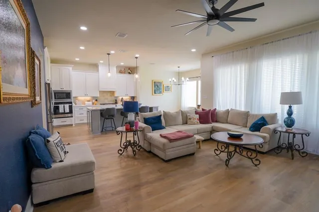 a living room with furniture and kitchen view