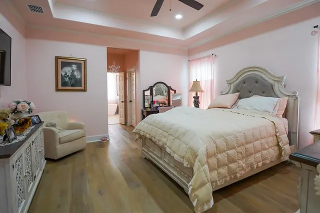 a bedroom with bed couch and window