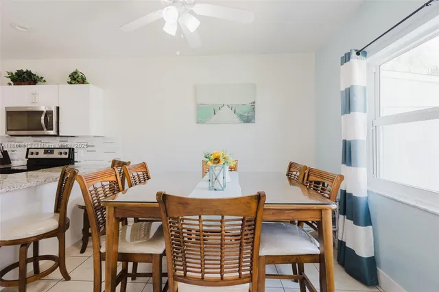 a view of a dining room with furniture and a window